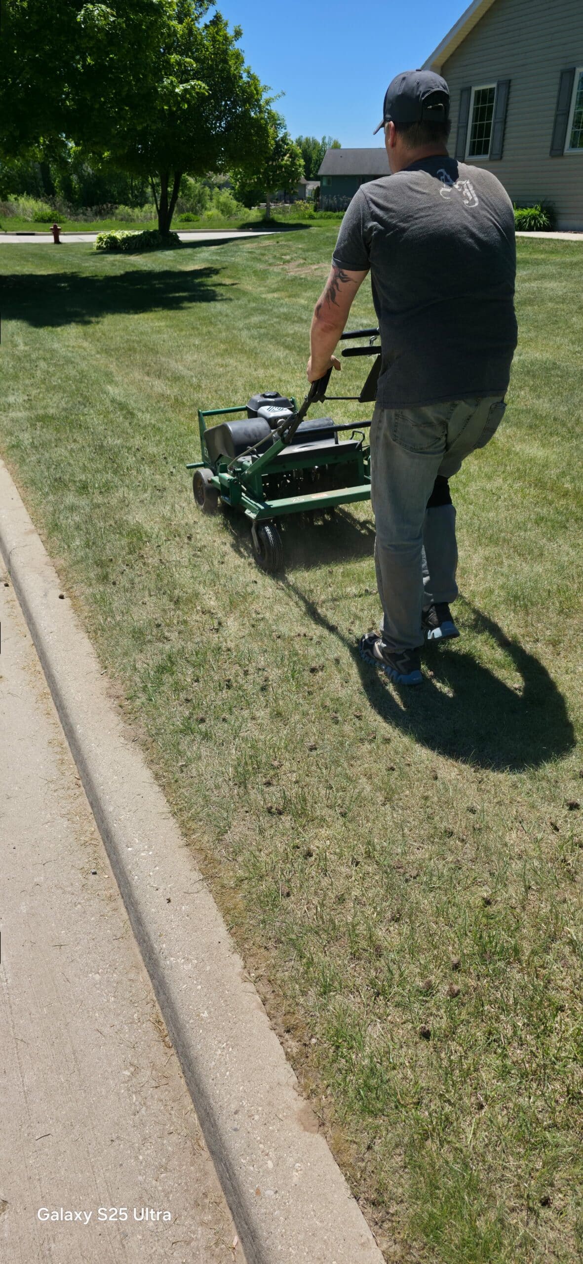 Core lawn aeration in Manitowoc WI — soil plugs pulled by Fast Grass Lawns